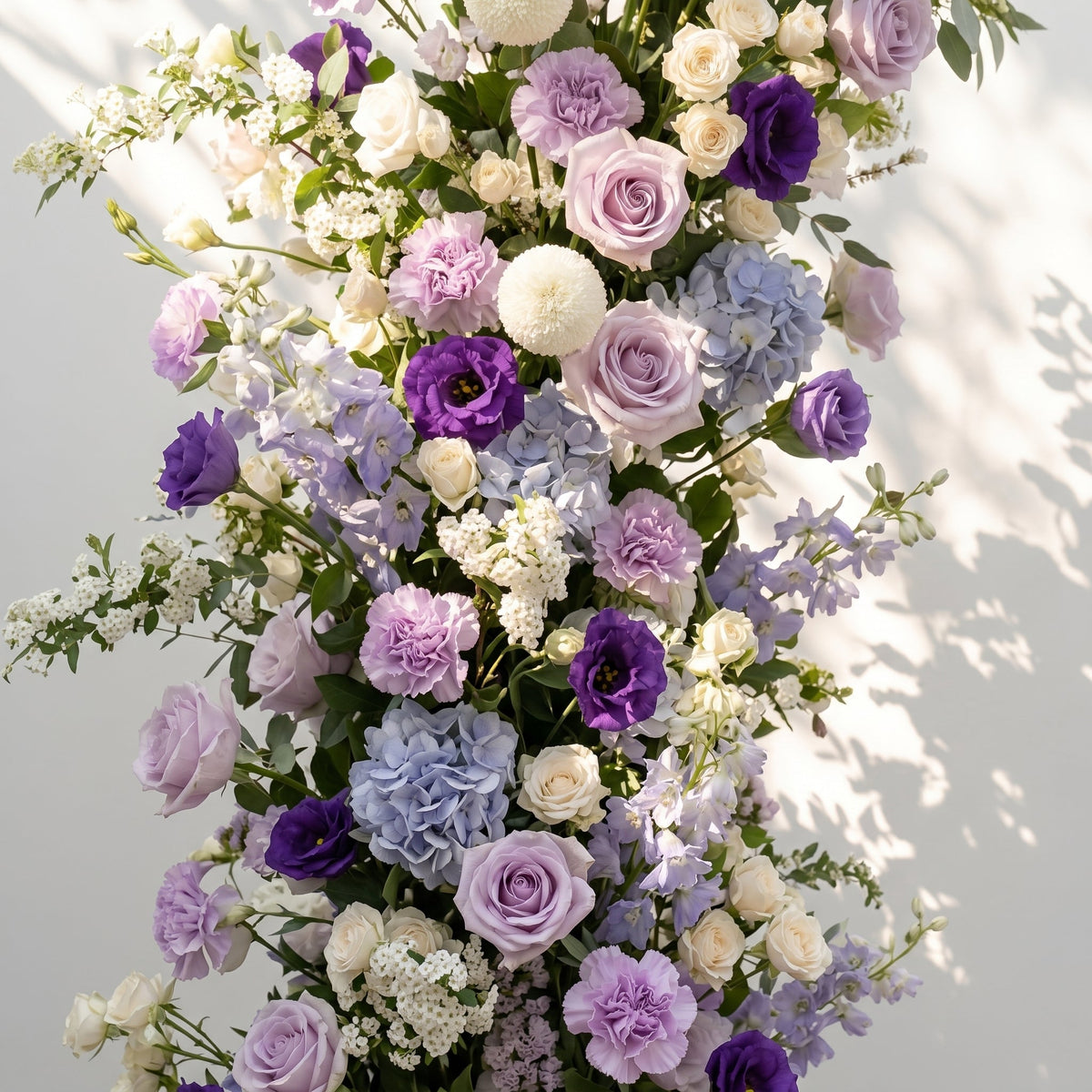 Marmere: Luxury Lavender Purple, Ivory White & Dusty Blue Silk Floral Ground Horn Arch Arrangement with Soft Delphinium & Lush Cascading Greenery for Romantic Minimalist Weddings & Garden Event Decor Including Frame