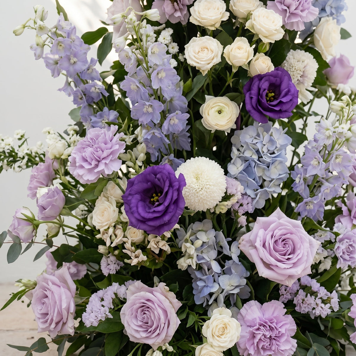 Marmere: Luxury Lavender Purple, Ivory White & Dusty Blue Silk Floral Ground Horn Arch Arrangement with Soft Delphinium & Lush Cascading Greenery for Romantic Minimalist Weddings & Garden Event Decor Including Frame